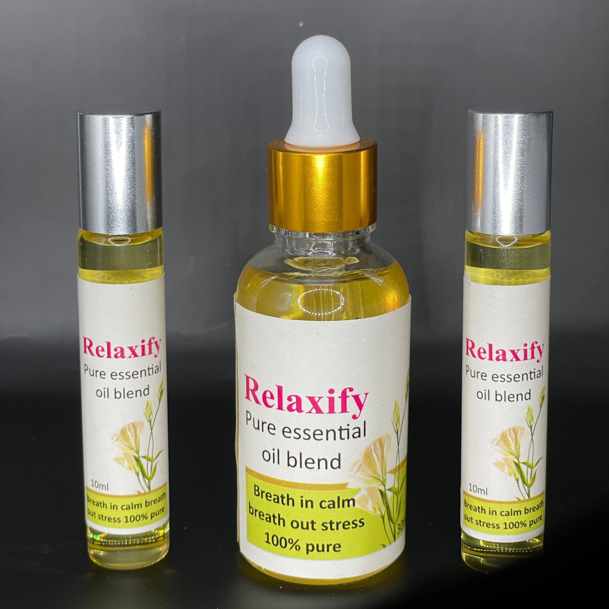 Three bottles of Relaxify essential oil blend on a dark background